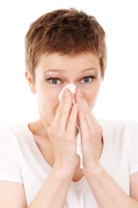 woman blowing nose
