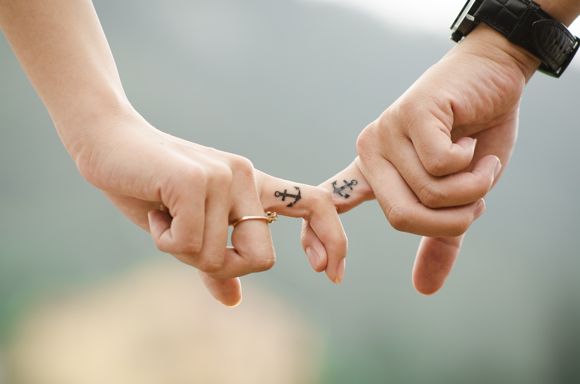 holding hands matching tatoos