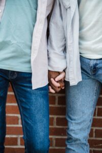 Jeans couple holding hands